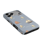 Harbor iPhone case featuring a light blue background with sailboat designs in various colors and styles.