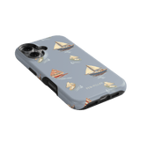 Harbor iPhone case featuring a light blue background with sailboat patterns in various colors and styles.