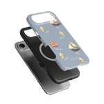 Harbor iPhone case featuring a light blue background with sailboat designs and a black and silver phone case underneath.