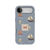 Harbor personalized iPhone case featuring a blue background with various sailboats and a central monogrammed 'H'.