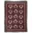 Haven woven blanket featuring a floral pattern in pink and green on a burgundy background with fringed edges.