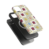 Heirloom iPhone case featuring a geometric pattern in pastel colors on a black phone case background.