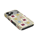 Heirloom iPhone case featuring a geometric pattern in pastel colors with cutouts for camera and ports.