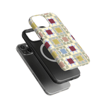 Heirloom iPhone case featuring a colorful geometric pattern, layered over a black phone case with a circular design.