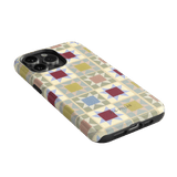 Heirloom iPhone case featuring a geometric pattern in pastel colors with a black edge and cutouts for buttons.