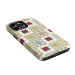 Heirloom iPhone case featuring a geometric pattern in pastel colors with a black edge and cutouts for camera and ports.