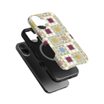 Heirloom iPhone case featuring a geometric pattern in pastel colors, layered over a black phone case.