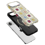 Heirloom iPhone case featuring a geometric pattern in pastel colors, layered over a black and white phone case.