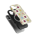 Heirloom iPhone case featuring a geometric pattern in pastel colors, layered over a black and silver phone.