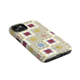 Heirloom iPhone case featuring a geometric pattern in pastel colors with a black edge and cutouts for buttons and ports.