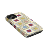 Heirloom iPhone case featuring a geometric pattern in pastel colors with a black edge and cutouts for buttons and ports.
