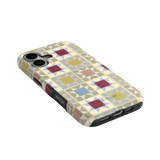 Heirloom iPhone case featuring a geometric pattern in pastel colors with a textured finish and camera cutouts.
