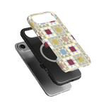 Heirloom iPhone case featuring a geometric pattern in pastel colors, layered over a black phone case.