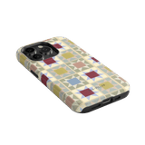 Heirloom iPhone case featuring a geometric pattern in pastel colors on a black edge.