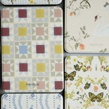 Heirloom Kindle case featuring floral, geometric, and butterfly patterns in various colors and textures.