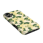 Hydrangea iPhone case with a yellow background and white floral design, angled to show side and camera cutouts.