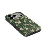 In the Garden iPhone case featuring a green background with floral and gardening-themed illustrations.