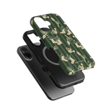 In the Garden iPhone case featuring a green background with floral and gardening tool designs, shown at an angle.