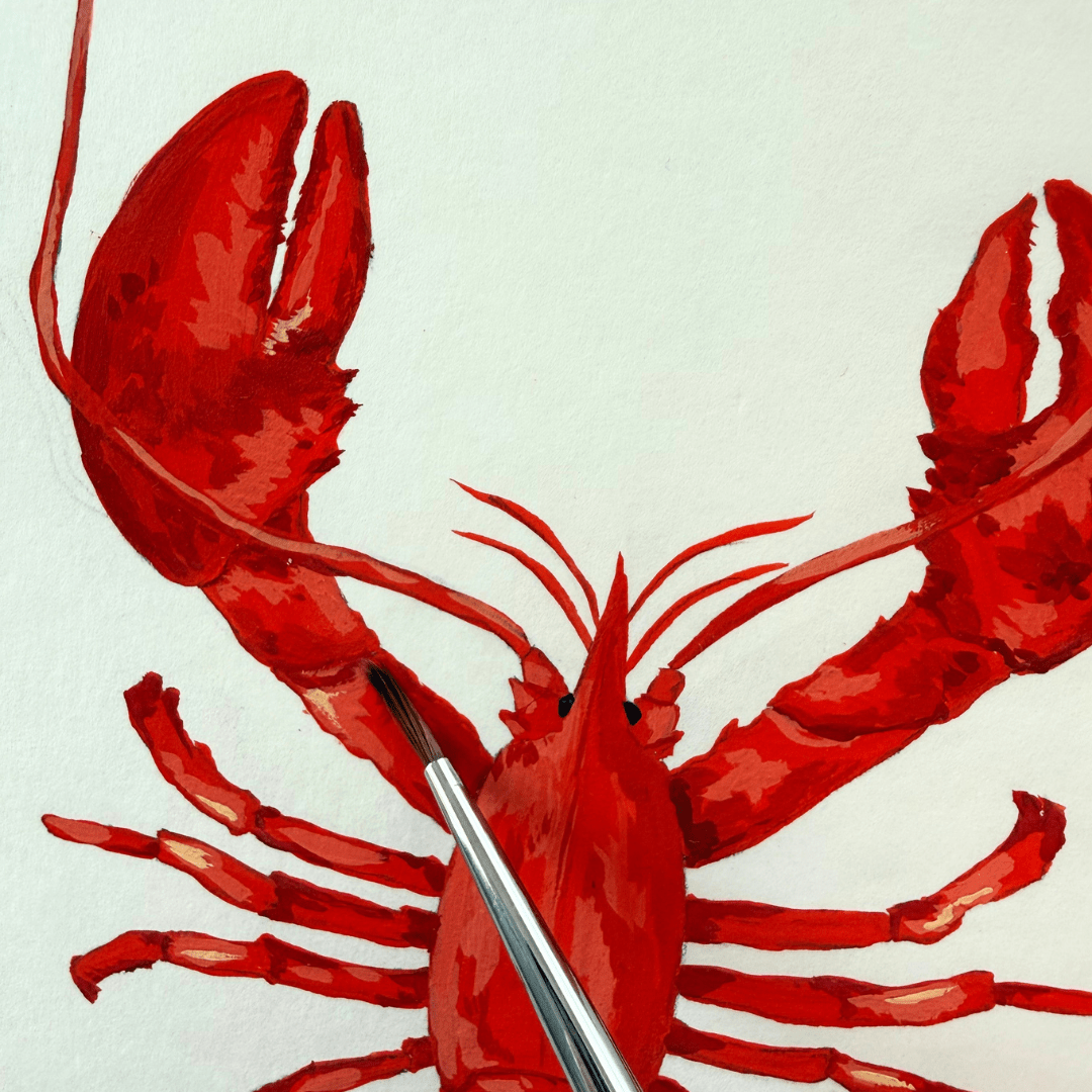 Red painted lobster on a white background with a silver paintbrush touching one of its claws.