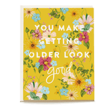 Yellow birthday card featuring floral designs and the text "You make getting older look good.