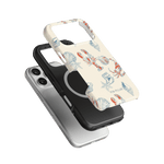 Mariner iPhone case featuring a lobster and shell design in vibrant colors, stacked on two solid black and white cases.