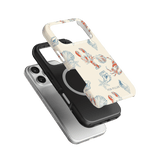 Mariner iPhone case featuring a lobster and shell design in vibrant colors, stacked on two solid black and white cases.