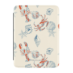 Mariner Kindle case featuring a cream background with red lobsters, blue crabs, and seashell illustrations.