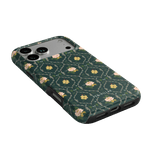 Meadow iPhone case featuring a dark green background with floral patterns and a textured finish.