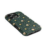 Meadow iPhone case featuring a dark green background with floral patterns and a textured finish.