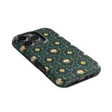 Meadow iPhone case featuring a dark green background with floral patterns and a textured finish.