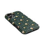 Meadow iPhone case featuring a dark green floral pattern with pink flowers and a textured finish.
