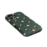 Meadow iPhone case featuring a dark green floral pattern with pink flowers and a textured finish.
