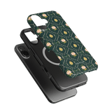Meadow iPhone case featuring a floral design on a dark green background, layered over a black phone.
