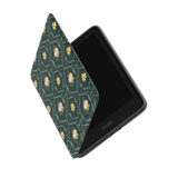 Meadow Kindle case featuring a floral pattern on a green background, partially open to reveal the device inside.