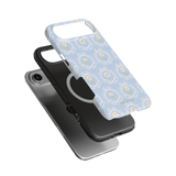 Merrigold iPhone case featuring a light blue floral design over a black phone case, showcasing a layered view.