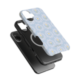 Merrigold iPhone case featuring a light blue floral design with a black phone case underneath.