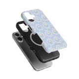 Merrigold iPhone case featuring a light blue floral design, stacked with a black and silver phone case.