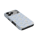 Merrigold iPhone case featuring a light blue floral pattern with yellow accents and a protective black border.