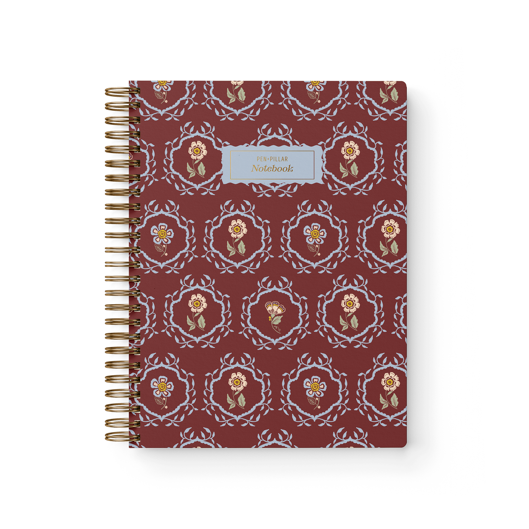 Merrigold notebook with a maroon cover featuring floral patterns and a gold spiral binding.