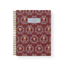 Merrigold notebook with a maroon cover featuring floral patterns and a gold spiral binding.