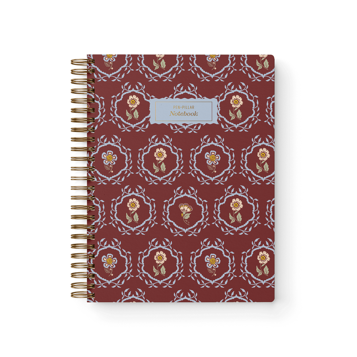 Merrigold notebook with a maroon cover featuring floral patterns and a gold spiral binding.