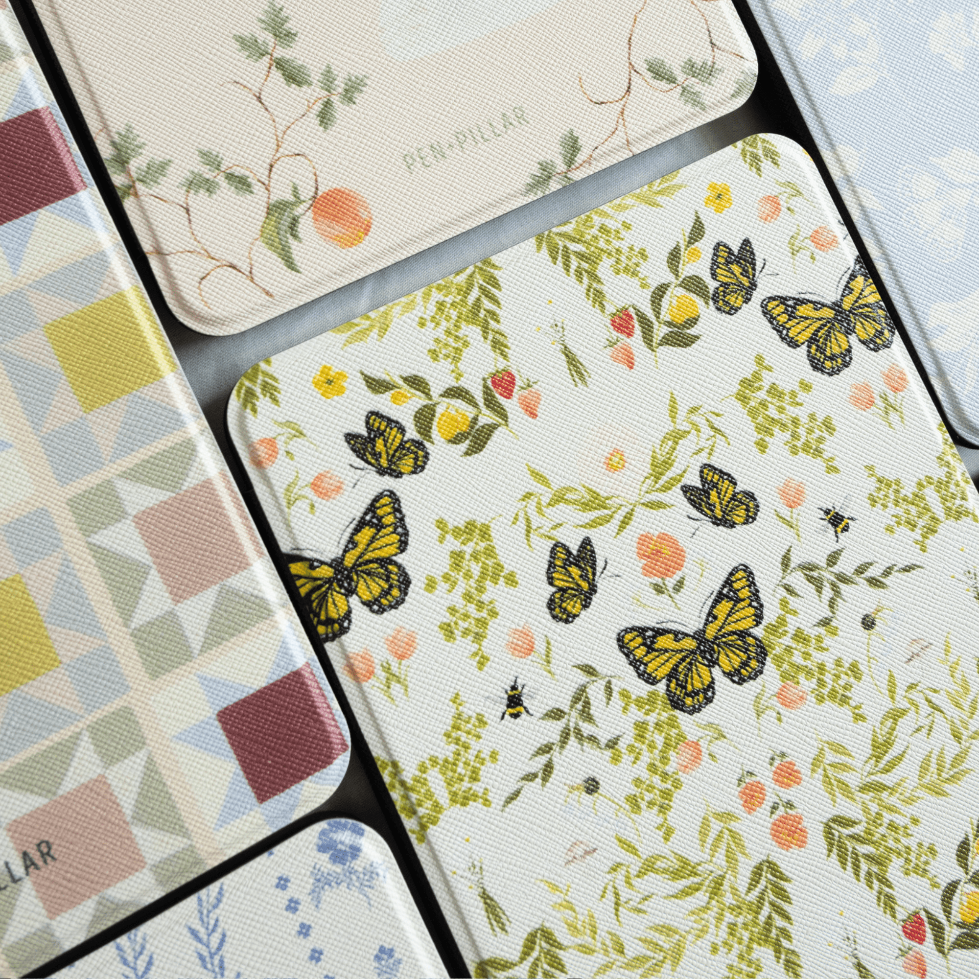Monarch Kindle case featuring a floral design with butterflies in yellow and green on a white background.