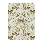 Monarch Kindle case featuring a floral and butterfly design in yellow, green, and pink on a light background.