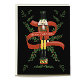 Nutcracker holiday card featuring a colorful nutcracker with a "Merry Christmas" banner on a black background.
