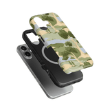 Orchard iPhone case featuring a green and beige tree pattern, with a black protective layer underneath.