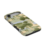 Orchard iPhone case featuring a landscape design with trees and hills in green, beige, and blue colors.