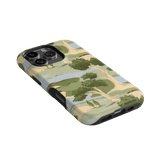 Orchard iPhone case featuring a green and beige landscape design with trees, angled view showing camera cutout.