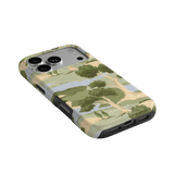 Orchard iPhone case featuring a landscape design with trees and a soft color palette, angled view showing ports.