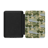 Orchard Kindle case with a camouflage design featuring trees and water, opened to show the interior.