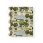 Orchard notebook featuring a landscape design with trees and water, spiral binding, and a beige label on the cover.
